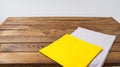 Grow and yellow paper napkin on empty table, food background, mock up Royalty Free Stock Photo