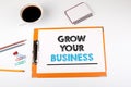 Grow your business concept. Office desk with stationery Royalty Free Stock Photo