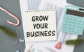 Grow your business words on office table with calculator, notepad, smartphone Royalty Free Stock Photo