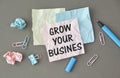 Grow your business words on office table with computer, coffee, notepad, smartphone Royalty Free Stock Photo