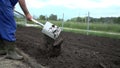 Grower uses the shovel to make some holes into the plowed field