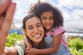 Growing both plants and young minds. Cropped selfie of an attractive young woman and adorable little girl working on a Royalty Free Stock Photo