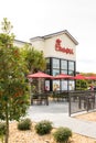 A growing Christian fastood chain restaurant - Curbside wide angle portrait view