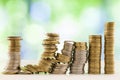 Growing coins stacks with green and blue sparkling bokeh background. Financial growth, saving money, business finance wealth and Royalty Free Stock Photo