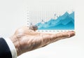 Growing graph chart of business financial on male hand. Royalty Free Stock Photo