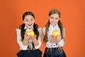 Growing in health. School children with healthy apple snack. Little girls taking school snack. Small girls eating