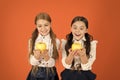 Growing in health. School children with healthy apple snack. Little girls taking school snack. Small girls eating