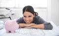 Growing her company and savings. a young architect resting on some blueprints and looking at a piggybank. Royalty Free Stock Photo