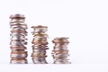 Growing money graph on a row of coin and pile of bath coins stack on white background finance business isolated Royalty Free Stock Photo