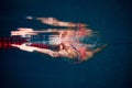 Young woman, professional swimmer in goggles and cap training in swimming pool. Underwater view. Concept of sport Royalty Free Stock Photo