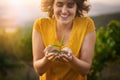 Growing up green. a happy young woman holding a small seedling in her cupped hands while standing outside. Royalty Free Stock Photo