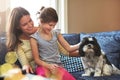 Growing up in a home of animal lovers. an adorable little girl, her mother and their dog spending time together at home. Royalty Free Stock Photo