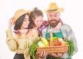 Grown with love. Parents and daughter celebrate harvest. Harvest festival concept. Family farmers gardeners vegetables