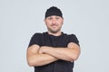 Grown man in a black cap and t shirt crossed his arms over his chest Royalty Free Stock Photo