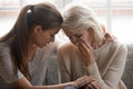 Grownup daughter soothe aged mother holds her hand feeling empathy Royalty Free Stock Photo