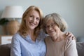 Grownup mature daughter and elderly mother posing at home Royalty Free Stock Photo