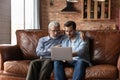 Grownup son and old father use laptop at home Royalty Free Stock Photo