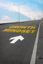 Growth mindset with white arrow marking on road surface Royalty Free Stock Photo