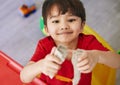 Growth, portrait and asian boy child playing with toys in bedroom of home for development from above. Face, game and Royalty Free Stock Photo