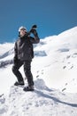 Growth Portrait bearded male skier aged against background of snow-capped Caucasus mountains. An adult man wearing ski