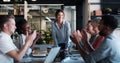 Growth is a result of everyone working together. a group of businesspeople clapping during a meeting in a modern office. Royalty Free Stock Photo