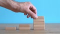 Growth, target, upskill concept. Growth of wooden cubes on a clean background. Business, economics, strategy idea