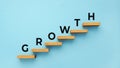 Growth word on staircase on blue background