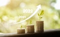 Growth year 2020 to 2022. Business graph with arrow up. Growing money coins stack. Plant growing up on coin Royalty Free Stock Photo