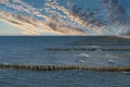 groynes on the beach of the Baltic Sea in Zingst. Waves break on the wood Royalty Free Stock Photo