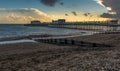 Groynes and pier protrude seaward as dusk falls in Worthing, Sussex, UK Royalty Free Stock Photo