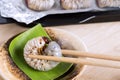 Grub Worms or Coconut Rhinoceros Beetle. Insects food for eating larvae fried or baked on plate with chopsticks and on baking tray Royalty Free Stock Photo