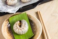 Grub Worms or Coconut Rhinoceros Beetle. Insects food for eating larvae fried or baked on plate with chopsticks and on baking tray Royalty Free Stock Photo