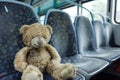 grubby teddy bear left on empty bus seat Royalty Free Stock Photo