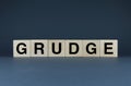 Grudge. Cubes form the word Grudge