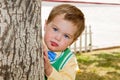 Grumpy Boy Peeks Around a Tree