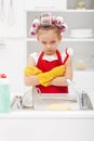 Grumpy little girl washing dishes