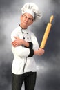 Grumpy Looking Chef Holding A Rolling Pin Close Up