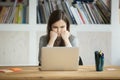 Grumpy not amused office worker looking at laptop screen.