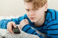 Grumpy petulant teenage boy watching television Royalty Free Stock Photo