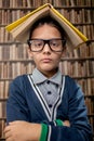 Grumpy young boy in library Royalty Free Stock Photo