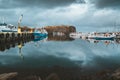 Grundarfjordur, Iceland - 03 January 2019: Harbor with motionless boats during the twilight of the afternoon, Kirkjufell