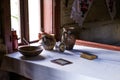 Grunge aged country style interior. Table with clay dishes, pottery.