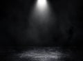 Studio dark room with spot lighting and fog or mist on concrete floor grunge texture background.