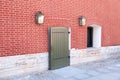 Grunge background of arch wooden door, grid on the window and red ancient bricklaying of 18th eyelid Royalty Free Stock Photo