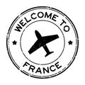 Grunge black welcome to France word with airplane icon round rubber stamp on white background