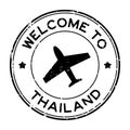 Grunge black welcome to Thailand word with airplane icon round rubber stamp on white background