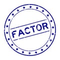 Grunge blue factor word round rubber stamp on white background