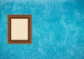 Grunge blue stucco wall with empty picture frame Royalty Free Stock Photo