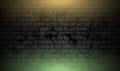 Grunge brick wall with orange green neon illumination abstract background