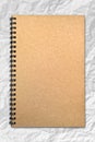 Grunge brown cover notebook on wrinkled paper